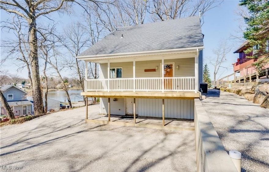 This stunning lakefront home offers 3 bedrooms, 1.5 bathrooms and a fully updated kitchen with modern appliances. From the moment you walk in, you'll be captivated by the breathtaking views of the water. Step out onto the spacious 12x27 composite deck, perfectly designed for entertaining or simply relaxing with a morning coffee. Large windows in the dining area bring the outdoors in, filling the home with natural light and scenic views. Enjoy direct access right from your backyard - ideal for kayaking, evening meditation, or soaking in unforgettable sunsets. On the 4th of July, you'll have a front-row seat to the firework display from the comfort of your own property. This home has an open living concept, a new hot water tank and AC unit and many other updates. This home features ample parking and mature trees that provide both shade and privacy making it a true lakeside retreat.