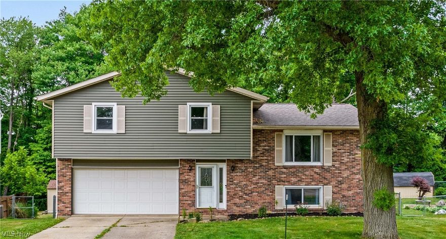 This Beautiful Home in Tallmadge has been lovingly maintained and updated by the current owners, now it could be your turn to own this Gem! Nestled back in a Quiet Neighborhood, this Split Level offers over 2000 square feet of Finished Space. The Front Door opens to the foyer where you'll follow the steps up to your Spacious Living Room. Oversized Windows and sliding Glass Doors let in abundant Natural Light on the First Floor. From the Living Room, a wide doorway leads you to the Dining Room and Kitchen. Luxurious wood-look flooring compliments the Hardwood Cabinetry and Corian Countertops. Stainless steel appliances offer durability, functionality, and style. Upstairs you will find your 1st Full Bath, completely updated with a fiberglass tub, Custom Tile Surround, new Ceramic Tile Flooring, Vanity, and Mirror. Continue down the hall to find the Master Bedroom (measuring almost 300 sq ft!) complete with His and Hers closets. Bedrooms 2 and 3 also have massive closet space, and All 3 B