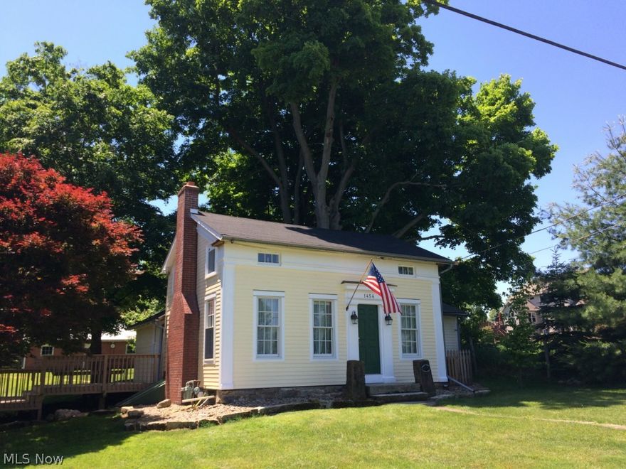 Charming Western Reserve home is nestled on a beautiful treed lot with creek, rebuilt timber frame farm barn, workshop, huge hardwood trees, exposed bedrock, and pasture, all on 2.2 acres. Home is almost completely remodeled with significant attention to detail. Bathroom is a gut remodel with black/white tile floor, subway tile, claw foot tub/shower. pedestal sink, and custom cabinets. Living room/foyer have exposed timber frame ceiling joists, oak staircase, hardwood floors, and wood stove. Kitchen has custom vintage cherry cabinets/granite counters. Master bedroom is spacious with added closets and hardwood floor. Second bedroom has original wide-plank floor. Loft is spacious and can easily serve as an office/guest room. House is 95% insulated with most windows replaced with Anderson 400 series. Electrical system new with 200 amp service, circuit box, and 98% of wiring. Sewer plumbing new including connection to public sewer in 1999. Copper water supply, central air conditioning 2004