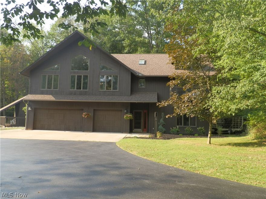 Recently reduced- This home may be the best kept secret in the Canfield school district! Amazing location central to shopping and rt 11, but surrounded by privacy & woods. The house is situated on 1.23 wooded acres, & is a reverse floor plan/ raised ranch for the benefits of privacy, seclusion & spectacular views. The entry level features a 3 car attached garage, utility rm, laundry rm, & family room w/ new flooring, sliding glass doors that lead to the back yard & a spiral staircase leading to the second floor. The upper level features an open floor plan, including a gourmet kitchen w/ stainless appliances, granite counter tops, & breakfast bar. It is open to the dining room & living room (new carpet). The master bedroom features a private balcony & spa like master bathroom w/ large steam shower with dual shower heads and body sprays. 2 additional bedrooms share another full bath & each have their own private balconies. There are vaulted ceilings & skylights throughout, & 2 zoned HVAC