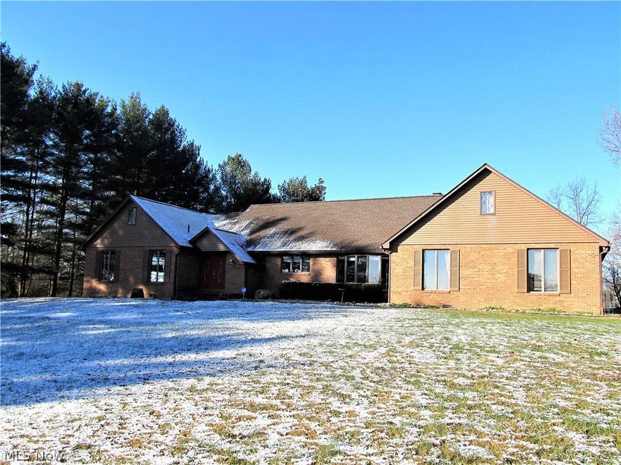 Privacy galore on 18.41 acres with more than you could ever ask for! A stunning 3 bedroom, 2 bath ranch offering over 3,600 sq ft of finished living space and large windows provide a ton of natural light with beautiful views all around. Quality updates throughout include gorgeous hardwood floors, awesome master suite and master bath with heated travertine tile floors, granite counters, huge glass tiled shower, and Jacuzzi tub. A kitchen any chef would love features granite counters, an abundance of cabinet space, 5 burner Jenn Air range, double ovens, wine cooler, and new cork tile floors. A 39x11 three-seasons room offers travertine tile floors, 6 new sliders, and splendid views. A partially finished walkout basement features a recreation room and storage room. Brand New Roof 11/2018.  An incredible bonus is a 60 x 56 multi-purpose building which houses a 3,360 sq ft workshop w 12 ft ceilings, 6 in. concrete floors, 2 overhead cranes, a separate 400 amp service and 1/2 bath. A complet