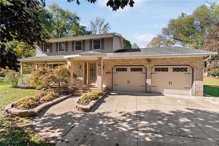 Welcome to this beautifully renovated colonial in a desirable Uniontown neighborhood within the Green Local School District. Set on over half an acre, this 3-bedroom, 2.5-bath home offers 2,102 sq. ft. of thoughtfully renovated living space, plus a partially finished basement for added flexibility. Step through the bright, inviting entryway and notice the attention to detail throughout–new stair thresholds, elegant iron-and-wood banisters, fresh neutral paint, and modern lighting. The open floor plan connects the kitchen, dining, and living areas—ideal for entertaining or relaxing at home with the family. The kitchen features solid wood cabinetry and updated stainless steel appliances, while the family room charms with wood ceiling beams, a brick fireplace with built-ins, and French doors leading to the back deck. Upstairs offers three bedrooms, two full baths, and a convenient laundry room with built-in storage. Enjoy multiple outdoor living spaces: a front porch, brick patio, and raised deck with gazebo overlooking a private, fenced-in yard with mature trees and a fire pit. Major updates include a new furnace, central air, and tankless water heater (2025), ADT security system (2024), LVT flooring, and deck improvements (2020). A smart thermostat adds modern convenience. Stylish, move-in ready, and full of charm– this home truly has it all!