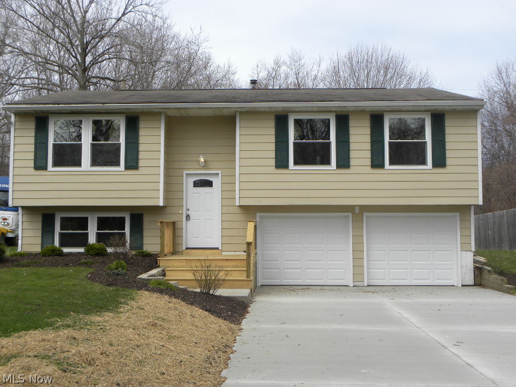 Pretty as a picture updated bi-level home with all the extras. Great room with fireplace overlooking deck and spacious backyard. Four bedrooms, wall to wall carpet and two baths. Modern updated kitchen with new cabinets, countertops and flooring. Many, many updates including: new flooring, new paint, new fan fixtures, new kitchen cabinets, new kitchen counter tops, new bathtub, new fans, new light fixtures, new furnace, new sliding glass door, new garage door, new front door, new front porch, new concrete pad and much more!
