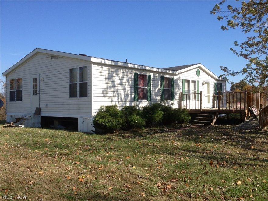 This manufactured home offers you 3.01 acres , beautiful country setting , 3 bedrooms, 2 full baths , extra large 2 car detached garage . Maysville Schools.  Banked Owned property . Being sold ' AS IS ' .  Call for your private showing . Shared driveway, first garage on your left IS NOT PART OF THE PROPERTY !