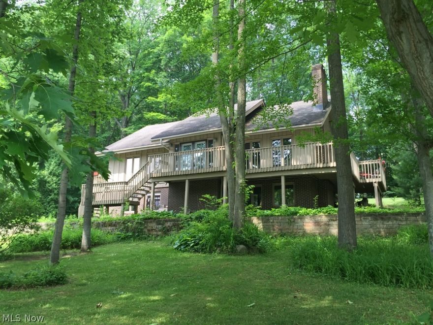 You must see this impressive home on the water in Twin Lakes! Situated on a lot that is over 0.6 acres, wooded and green, you will love the outlook from the front yard and the back. You can enjoy the lovely surroundings on the wrap around deck, the patio, or the enclosed porch! Inside, you will appreciate both large living areas (one is in the walk out basement), each with a fireplace to help you stay cozy in the colder months. The kitchen has beautiful hardwood floors, plenty of cabinet space, and is not only attractive, but functional. The dining area also features hardwood floors and has French doors leading to the enclosed porch. The bedrooms are nice sizes and with three full baths, you will find this home is ready for everyday life. If you want a peaceful outdoor setting that will charm you in all four seasons, an interior that will both wow and welcome you, and a place that is easy to call home, this could be the one for you!