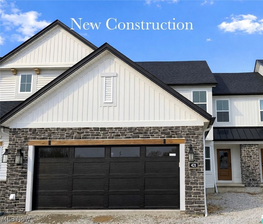 Gorgeous 3 bdrm Villa with 1st-floor primary suite, 1st-floor office, and walk-out basement with composite deck and lower level patio backing to protected conservation area now ready for move-in! This popular plan welcomes guests with loads of curb appeal, a covered entry, and a spacious, dedicated foyer. A 1st-floor office w/ glass door is ideal for those who need a quiet place to work or tend to a hobby, and the open concept design provides for easy entertaining. The kitchen boasts a dramatic 2-story ceiling, soft-close cabinetry, sizable pantry, and large quartz island along with plenty of space for a dining table. The great room features a gas fireplace w/ quartz surround, luxury vinyl plank flooring, & ample windows that let in an abundance of natural light. An 8' door opens to a huge 20 x 16 low-maintenance composite deck w/ views of the conservation area and community pond. The 1st floor primary suite feels roomy with a vaulted ceiling, ensuite bath w/ dual quartz vanities, tile shower, & large walk-in closet. A 1/2 bath and laundry room w/ utility sink off the 2-car garage complete the 1st floor. Spindle-railed, open-tread stairs lead you to the 2nd floor, where you'll find two more bedrooms, each with walk-in closets, and a full bath that offers access from both the hallway and a bedroom. Owners will love the walkout basement with 9' ceilings, full-bath rough-in, and 8' sliding doors that open to a large patio, providing another approx. 1500 sq. ft. ideal for future finishing. Upscale features and upgrades throughout, this stunner is situated in the sought-after Bordeaux Crossings community, located directly across the street from Michael Angelo's Winery. Easy access to I-77, I-271, and the new Valor Acres, this central location is ideal for those looking for quick access to downtown Cleveland or Akron & local amenities. Low-maintenance living w/ lawn care and snow removal handled by the HOA. Photos are of actual home, furniture is virtually staged.