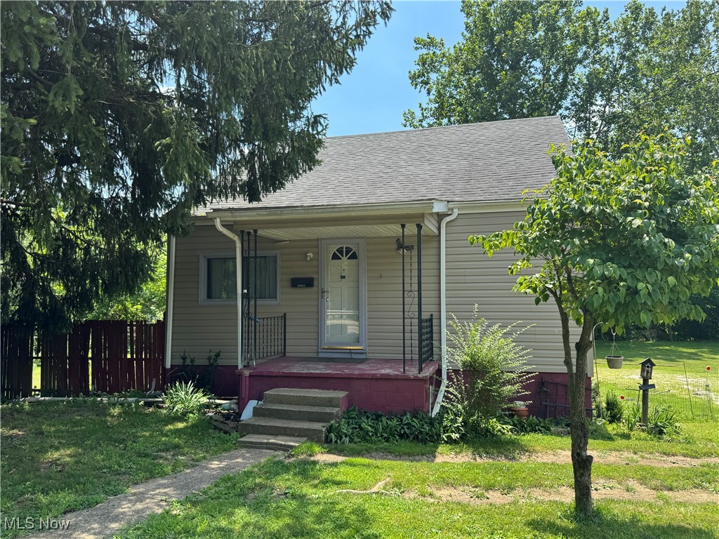 Single family home with 832 sq ft on main level with additional 208 Sq ft upstairs. On main level is two bedrooms one bath. With a little TLC a 3rd bedroom can be added on the 2nd floor (16'x13'), Gas furnace and hot water tank, one car attached garage, and a two-car detached carport. Situated along National Road with easy access to everything! Enjoy the sounds of the water flowing or just relaxing outside in the outdoors.