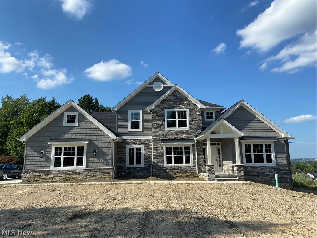 Custom built by Perry Homes with the quality and value you've come to expect. Builder financing with many options available including trade in of buyer's home. Perfectly sited on a gorgeous hilltop setting with breathtaking views of the Cuyahoga Valley and eastern suburbs. Stunning open floor plan with walls of windows to take advantage of the incredible views. Dramatic 2 story great room with coffered ceiling, stone fireplace & grid of 9 large windows. Chef's gourmet kitchen is wide open to the great room and features designer leathered granite counter tops, custom tile backsplash, huge walk-in pantry & large eating area with slider access to Trex deck. Spacious 1st floor master suite offers mesmerizing views plus large walk-in closet & luxurious master bath with custom tile shower. Dining room/flex space, Mud room/drop zone, 1st floor laundry & office (or 5th bedroom) complete the first floor. 3 generously sized bedrooms upstairs, one with en-suite full bath. Enormous basement with h