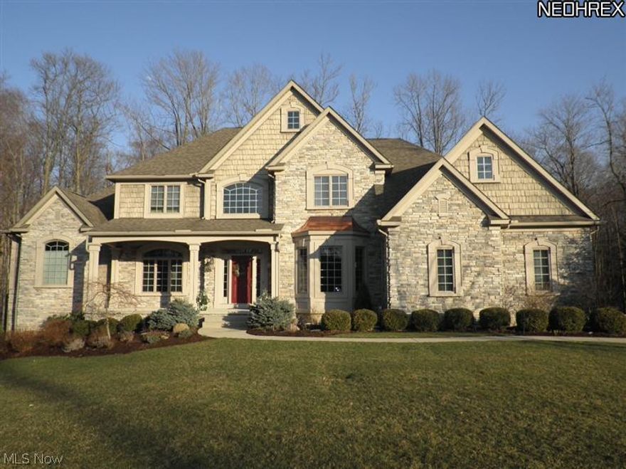 EXCEPTIONAL custom luxury home nestled on gorgeous, wooded 1.26 acre cul-de-sac lot backing to private preserve in Deer Creek Reserve.  Bright open floor plan features 2 story Great rm with hardwood floors, wall of stacked windows with beautiful views, and fireplace with built in cabinetry.  Great rm opens to spacious gourmet kitchen with an abundance of cherry cabinets, angled island, granite counters, walk in pantry, and cozy sunlit hearth room with stone fireplace. First floor master suite offers sitting area and private deck. Luxurious master bath with fabulous custom shower, double vessel sinks and his & hers closets. Handsome library is warmed by the fireplace with beautiful floor to ceiling mantel piece. Second floor offers three spacious bedrooms and 2 full baths. Finished walk out lower level with home theater and full bath. Beautiful millwork and custom built- ins throughout. Stone front exterior, pro landscaping, tiered patios and one of the prettiest settings in Richfield!