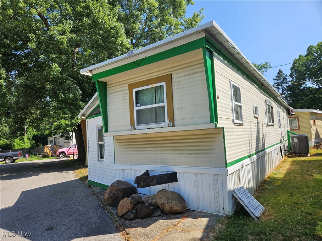 This well cared for mobile home is located across from the Springfield Lake! You can enjoy the view as well as walking path, playground & more. This is not a a drive by and you must see the inside! There are some nice features throughout that you won't find in too many mobiles. When you enter you are in an enclosed entry area. Then you will continue through and have the laundry room area and a bonus room! This would make a great home office, den, craft room or just a storage area (many possible uses). Then as you go up a few steps you will step inside the main living space which includes the living room, kitchen and a 2nd bedroom off of the kitchen. There is also another bedroom, walk-in closet and a full bath with a jetted tub! The furnace, C/A and roof are all newer. 1962 Vindale Lanewood model. **Easy access to Akron, Hartville, Green, Canton, CAK Airport, expressway and more! Close to shopping, restaurants, bus line, automotive and more.** Fire station, EMA and Police are located across the street too! Call to set up a time to see this home before it's gone!