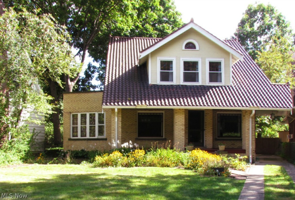 You won't believe how good the lake views are... From a great big, old fashioned front porch look right across Edgewater Park to Perkins Beach. Location doesn't get better than this. A short walk to the beach and the Yacht Club. Lakewood, Ohio City, Tremont and Downtown all minutes away, and Gordon Square within walking distance. Marvelous mid-20's Mission-style brick colonial, angled to look straight down to the beach. Lots of interesting detail, inside and out. A spectacular tile roof, fully restored with copper valleys. Gorgeous interior woodwork with beautifully refinished red oak floors. Large rooms, with a huge master bedroom with 8'x6' dressing rooms on either side, one opening onto a small porch. A large second floor garden deck off the landing, with beds of colorful perennials. Three year old furnace/boiler and 70 gallon water heater. Carefully restored bath on the second floor, and a new powder room on the first floor. Restored Mid-Century kitchen with stainless steel applia
