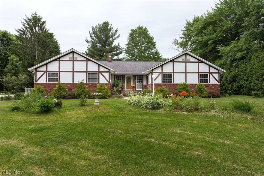 One Level convenience and country living just a outside the city limits. Set off the road and nestled in woods.  This home has a yard that feels like a park complete with a pond and mature trees. You will love the long concrete driveway and plenty of parking! Nice sized kitchen with center island, jenn air cooktop and bar stools. Formal dining room walks out to a covered porch to relax on a summer evening.  The large outbuilding has a workshop area and area for all your yard equipment. New roof on the barn 2015. Three bedrooms and two full baths, full unfinished basement. Newer Furnace and A/C, public water. Central vac system. Oversized 2 car garage with naturestone floor. Family room with gas log fireplace. One Year Buyer Home Warranty.