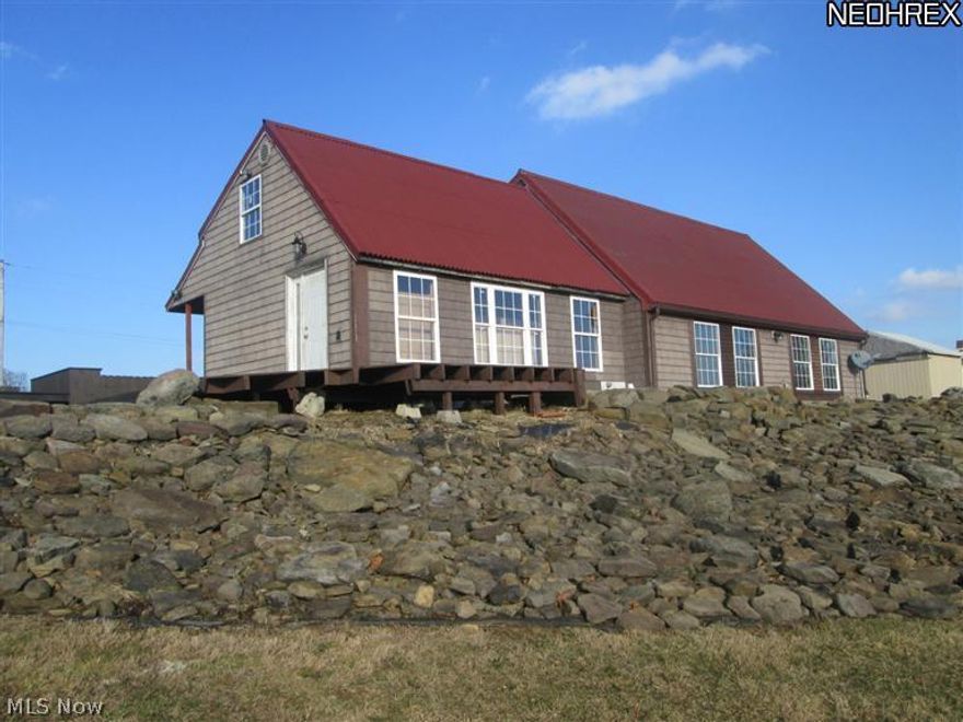 Incredible setting of this 1999 Salt Box style 2 bedroom home on 2.5 acres. Only 5 minutes to  Atwood Lake, Carrollton or Dellroy Atwood Lake. The owner has put in endless hours planning every detail in the home but now needs to move to be closer to work & is MOTIVATED to sell. The sunken great room & kitchen are the focal point that will please even the toughest critic with 13' towering ceilings with an incredible combination of materials from stainless steel to shakers. A full wall, stone gas fireplace is incredible with built in bookcases & accent shelving featured in the great room. The master bedroom offers a prvt bath & walk in closet in addition to a 2nd bedroom & stunning common bath. The new owner will be able to put their signature on the home with some minor trim, paint etc. that needs to be completed. Foundation in place to build a 2 car garage. The never ending decks, patios and porches are perfect for enjoying the tranquil setting & views. Mineral rights go to new owner.
