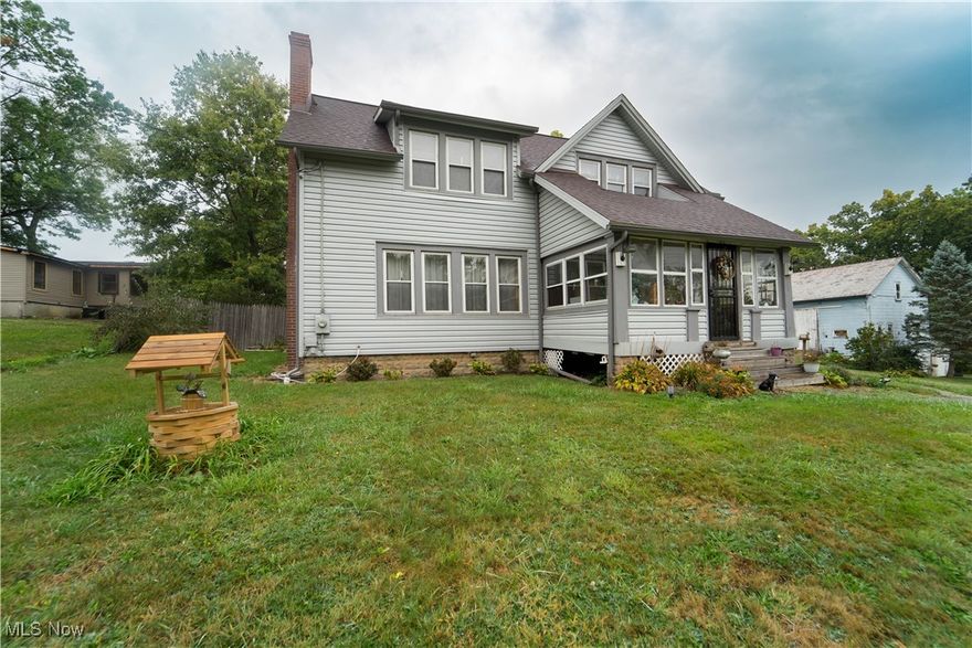 Welcome to 6179 Newton Falls Rd, Ravenna, OH 44266. Updated farmhouse located minutes from West Branch State Park. Move-in-ready home sits on 5.38 acres and consists of 5 bedrooms (including 1 first-floor bedroom), 1 full bath, and 1 half bath. The fireplaced family room is calling your name for those cool Fall evenings to relax and enjoy! The 3-season room off the family room is a great place to start the day with your morning beverage. For gatherings small and large for the holidays, this home includes a beautiful formal dining area with lots of natural light. All the rooms have hardwood floors except bathrooms and kitchen. Multiple outbuildings on the property including a huge barn, chicken coop, and a separate carriage house featuring a living room, 2 bedrooms, kitchen, laundry, and bathroom with separate electricity. All the property is fenced except across the front. Updates include: roof over main house and back porch 2019 & 2024, new siding on main house 2019, new walls and stairs (Dorothy door) 2019, new insulation main house 2019, new. So much more to offer and opportunities for this fantastic property. Call today to see and make this your home for the holidays.