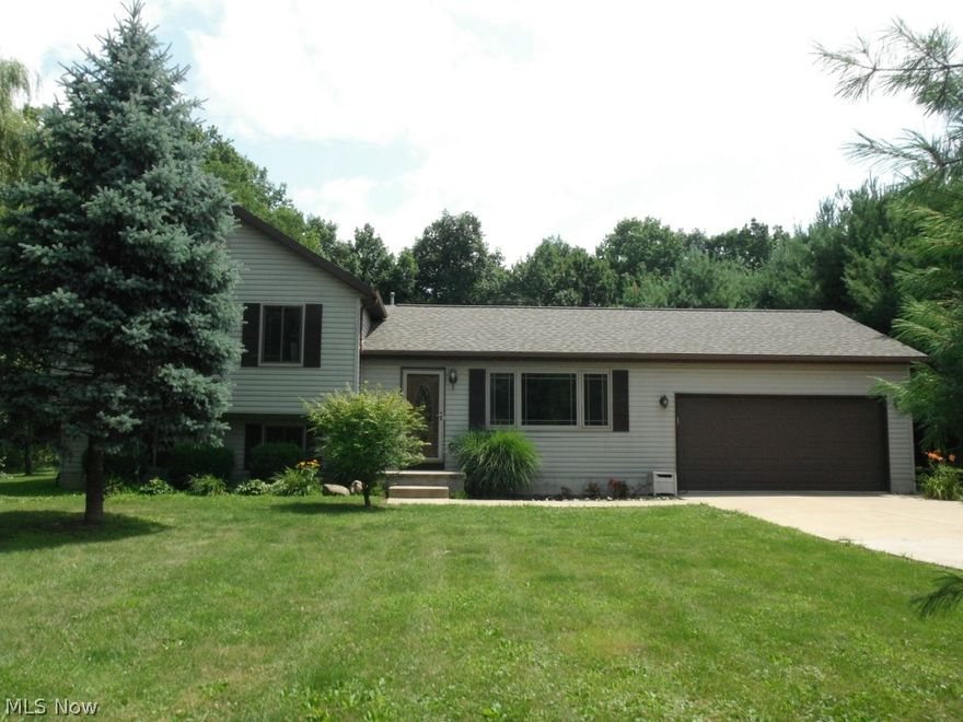 Tucked back from the road & surrounded by whispering pines, your home in the county awaits you! This 4-level split features an open layout w/a modern floor-plan that fits today's lifestyles. Kitchen highlights include ceramic tile flooring, under-cabinet lighting & breakfast bar! All appliances stay - refrigerator new in 2013! Lower level boasts family rm w/laminate flooring & woodburning fireplace plus a 4th bdrm. Huge rear deck offers fabulous outdoor entertaining space & the ideal spot to enjoy your 6+ acres of Mother Nature. Property consists of 2 parcels w/woods & two creeks. Other features incl. a master bath, 20x24 outbuilding, above ground pool, unfinished bsmt & a roof new in 2012. One year home warranty is also included.