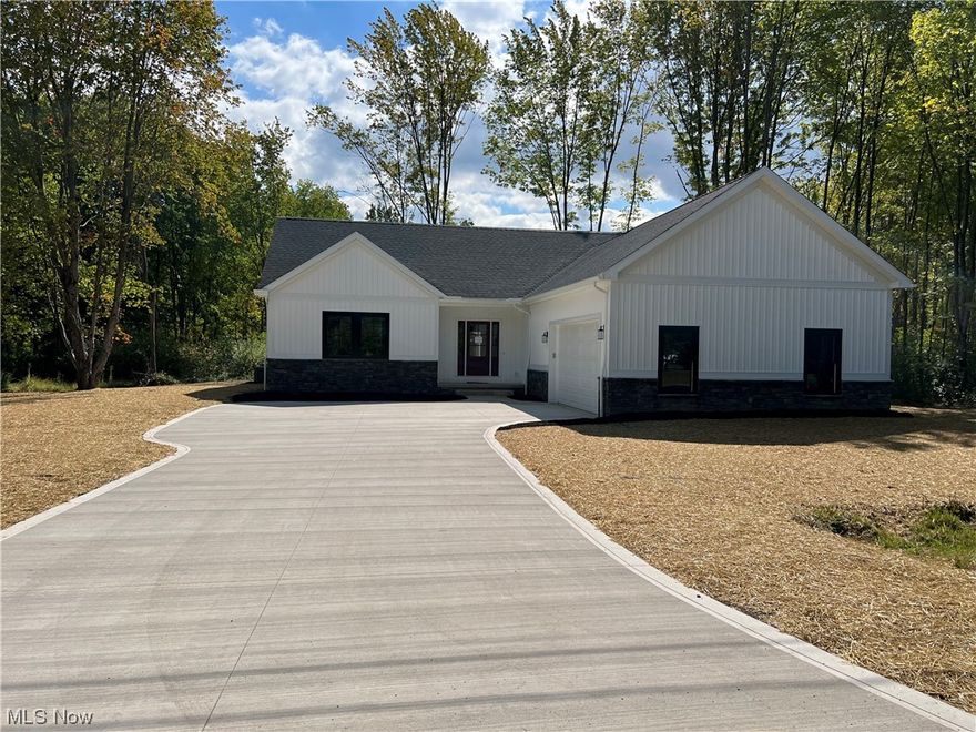 Beautiful Custom New Build with Boat Slip in picturesque Roaming Shores!!
 Welcome to this stunning 1750+ sqft open- concept Ranch with breathtaking wood floors a  stone gas fireplace, vaulted ceilings,and a wall of windows opening to an alluring covered patio. The Kitchen is fabulous ,custom cabintery  throughout with granite countertops, butcherblock island with prep sink. There is also a large pantry. This floor plan offers a split bedroom plan. Masterbedroom with vaulted ceiling, walkin closet, en-suite with a large walkin shower. The jack and Jill feature is pleasant with two bedrooms adjoining to a large bath with tiled and glass shower. Let's not forget the barndoor feature in the bathroom! The laundry room and powder room is sure to please, Amazing custom cubbies, a folding station for laundry. A full unfinished basement with nine foot celings is plumbed for a bath or bar and  has unlimited potential. Garage is completly insulated, hot and cold water and a charging station for those electric cars!!  Enjoy Lake Life at Lake Rome Rock with all of its amenities by Golf Cart, waterfront dining, beaches, heated pools, tennis and pickleball plus all the amazing clubs are just a short rid away!!