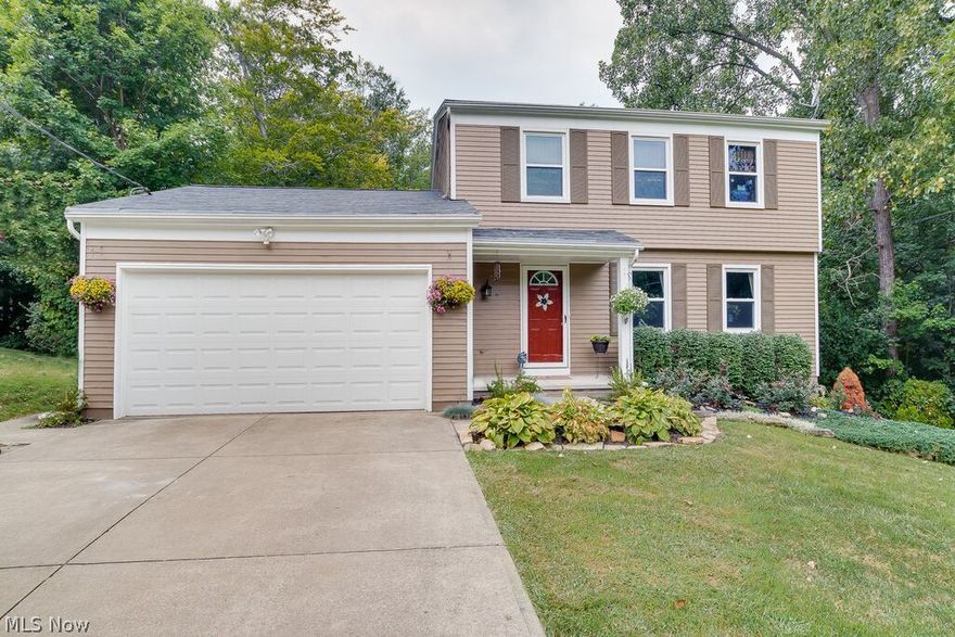 Updated Colonial on a Half Acre Wooded Lot! 3 Bedrooms, 2.5 baths on a quiet street. Inviting front porch and welcoming foyer. Formal living room. Spacious kitchen with beautiful cherry cabinets, granite countertops and a breakfast bar. Separate dining room is a good size. Family room features a floor-to-ceiling fireplace, built-in bookcases flanking each side and sliding glass doors to the deck. Convenient first floor half bath. Large master bedroom and a private bath. Two additional bedrooms and a full bath. Large deck overlooking the wooded backyard. Secluded setting! Full walkout basement is partially finished with a rec room and office, a laundry area and room for storage. Two car attached garage with additional storage. All appliances stay. America's Preferred Home Warranty included. Move-in ready!