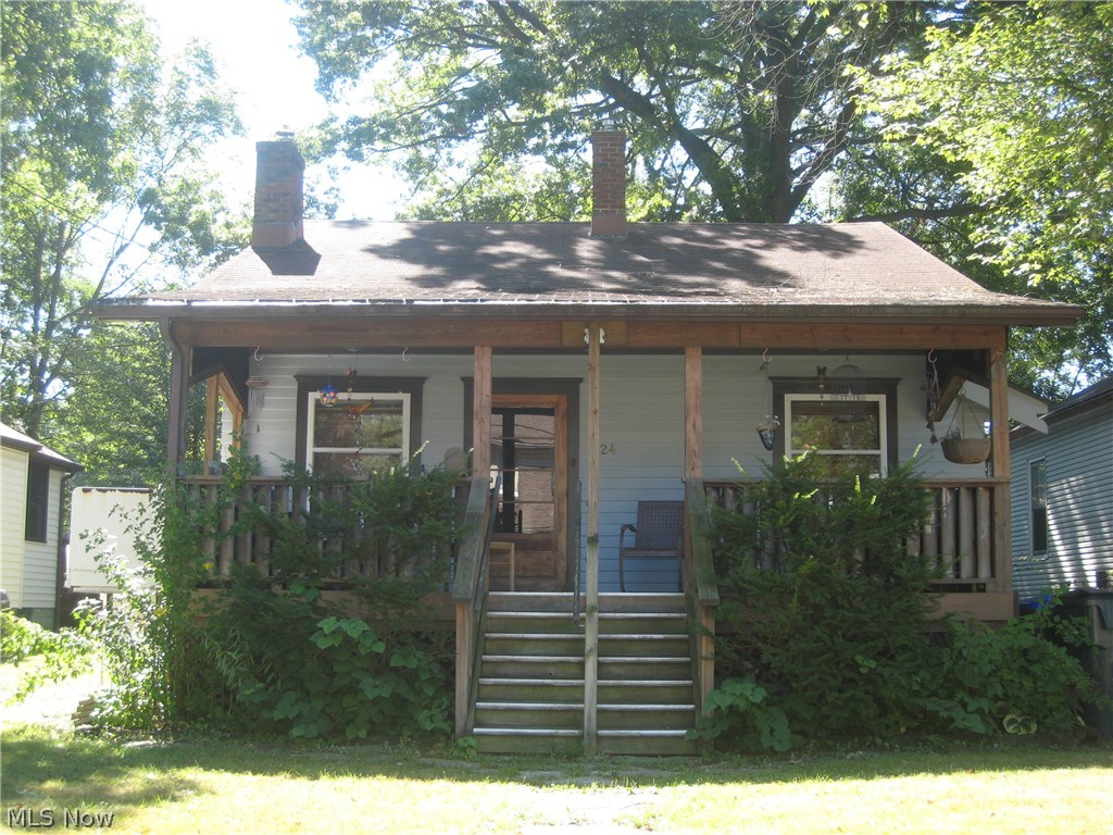 Walk back in time and appreciate the beauty of all hardwood floor, woodwork and trim. The living room features a stone wood burning fireplace and dining room with parquet ceiling, leaded glass cabinet and window seat. Step saving kitchen has appliances. 2-3 bedrooms and a full bath with tiled tub/shower. Plumbed for first floor laundry and washer and dryer stay. Unfinished basement has a sump pump, newer furnace and central air (2006). Welcoming covered front porch, recently rebuilt, perfect for outdoor gatherings, coffee in the morning and wine at night. Needs a little TLC, but a great little house.