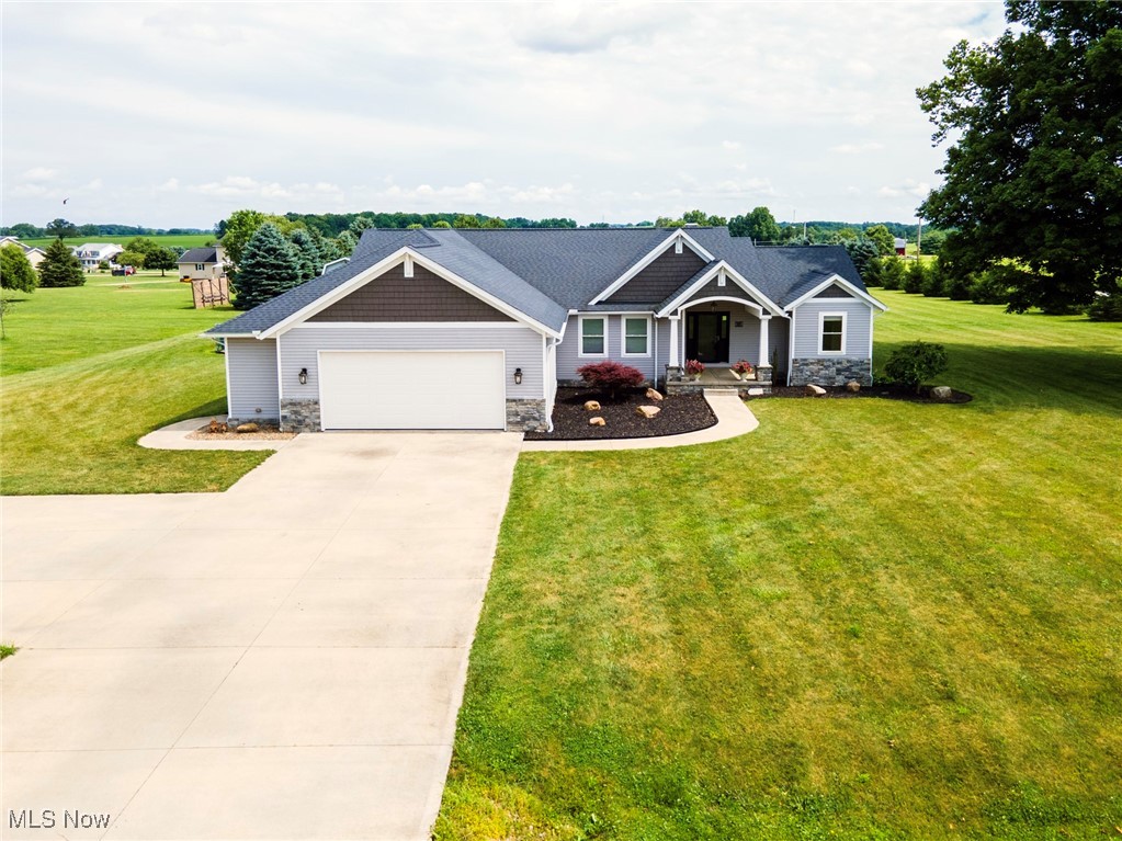 Homes like this don’t come around too often! Built in 2016, this beautifully designed home offers the perfect blend of functionality and comfort, set on just under 2 serene acres. Thoughtfully built with two spacious primary suites, each featuring double sinks and large walk-in closets, it's ideal for multigenerational living or guest accommodations. Two additional bedrooms share a Jack and Jill bath with double sinks, providing space and privacy for everyone.
The heart of the home is an open-concept kitchen and family room anchored by a cozy gas fireplace. A chef’s dream, the kitchen boasts a Bertazzoni gas range, abundant counters, pantry, and a large dining area that flows effortlessly to the outdoor patio. A four-season sunroom—with privacy doors—extends your living space and frames peaceful backyard views.
The oversized 2-car garage leads to a convenient mudroom/laundry area with a stylish barn door, just steps away from a half bath. Enter the basement through the garage or inside the house. Downstairs is another large living space with a full bath and a second kitchen featuring a nine-foot island, soft-close cabinetry, and deep sink—perfect for entertaining or accommodating extended stays.
Outside, a two-story workshop with electricity and a covered porch is ideal for hobbyists or yard equipment. Spend evenings relaxing on the Trex deck, patio, or around the fire pit, soaking in countryside sunsets.
Set in a rural landscape with wide-open views and tranquil surroundings, this home is ideal for those seeking peace—but with the convenience of shopping and dining options just minutes away.