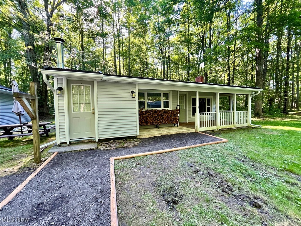 Welcome to the private oasis you've been looking for! Quaint and secluded, this full-time stay, or weekend retreat on 5 acres will get you back to nature, and help you embrace a lifestyle of rest and reset. Tucked back in the woods, at the end of a long and winding drive, this property offers the quiet space, privacy, and freedom you're seeking. This rejuvenated 2 bed ranch offers delightful features; new vinyl flooring, tongue-in-grove ceiling throughout, real timber beams framing the vaulted living room ceiling. Newer appliances. Stone and live edge accent wall. The house and garage are both vinyl sided with black metal roofing. Garage has a single lift door, along side a finished bonus room - which could be a working office or creative space. The two bay steel garage can be a workshop, with it's pellet and wood burner. Or, clear the footprint and build what you really want. The surrounding forest is healthy with a mix of mature and adolescent Cherry, Maple, and Oak. Never logged. Front to back, this lots teems with the rise and fall of interesting topography and birds singing. And really, you won't hear much else. Beyond the winding creek, the terrain climbs again, making plentiful height for a reliable campsite. Opportunity and space to carve in more trails. Plenty of room and contouring land for a shooting range. Two creeks crossing the lot bring the wildlife. Hunt your own land. And a wild strawberry patch just a few steps off the porch. Quiet life in the country. Don't wait. Don't miss this.