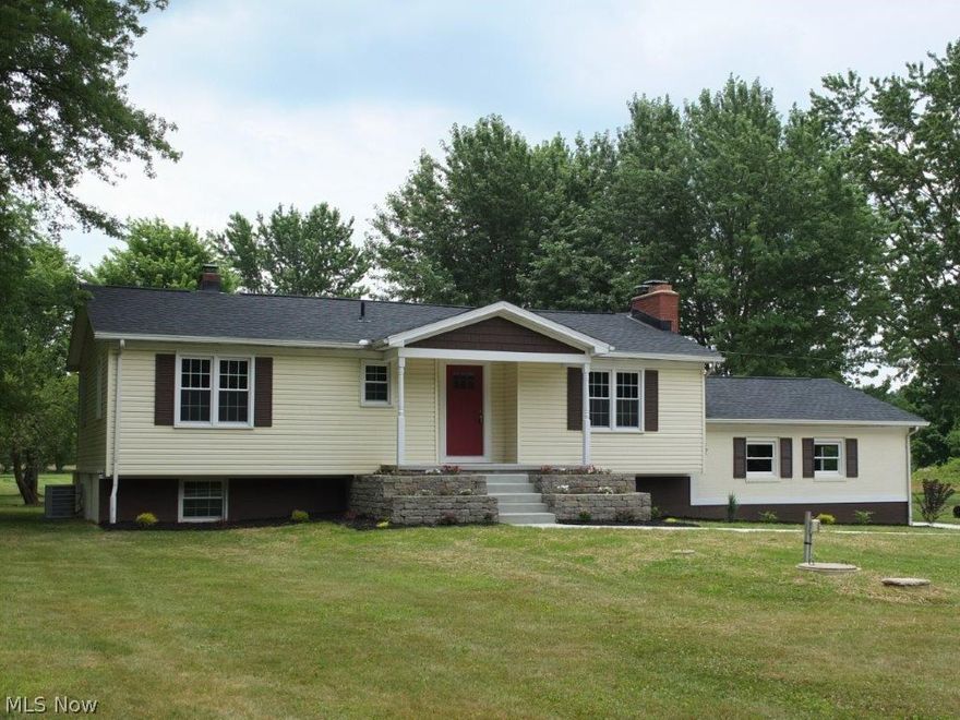 Stunning remodeled home on 3 acres in Marlington Schools! Open concept first floor with living room, dining room and kitchen - all with gorgeous wood flooring. Living room has a beautiful fireplace and dining room has French doors to back deck. Updated kitchen has a center island with breakfast bar, tile backsplash, granite countertops and tons of cabinet space. Kitchen comes applianced with stainless steel dishwasher, gas range, oven and over the range microwave. Master bedroom has two large closets plus access to updated full bath. 2 bedrooms on the main level and a remodeled full bath with new vanity, tile floor, tiled shower surround and linen closet. Spacious family room and additional bedroom on finished lower level. 2 car attached rear load garage with storage space above. Gorgeous backyard offers great deck for entertaining! A must see!