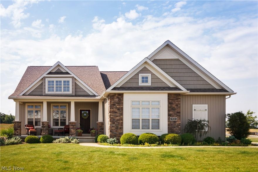 Character abounds in this custom built craftsman style story and a half at 900 Northampton Hartville, Ohio, in Danbury Glen. Quality you would expect from Rembrandt Homes! Welcoming front porch giving way to the foyer entry, which opens to the 2 story great room, offering cathedral, beamed ceiling, a stone fireplace, and a wall of windows with glass transoms. The kitchen, dinette areas are open to the great room, and provide perfect functionality incorporating  a breakfast bar, planning desk, pantry, stainless steel appliances, and granite counter tops. The dining area gives way to the patio and backyard through a sliding glass door. The practical, mud room, and a first floor laundry, can be accessed from the garage entrance into the house. A first floor master suite with a walk-in closet, and a full bath offering double sinks, double shower, and a garden tub, is a tranquil respite. The second floor landing can have many uses, and leads to the two bedrooms, and the uniquely styled Jack