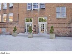 Don't miss this Historic Little Italy opportunity! This former Murray Hill school house has been transformed into high end urban living! Loft style master bedroom offers walk-in closet and full bath with the washer/dryer. Also, additional bonus loft space. Kitchen is open to large living room with dining room space. Remodeled in 2018. Updated include laminate flooring, and carpeting throughout, all newer appliances, updated lighting fixtures and ceiling fans. Freshly painted. Dedicated gated parking. Access to rooftop patio. Secure entrance to building. Ideal location close to University Circle and University Hospital. Maintenance fee includes water, sewer, trash, parking lot, and common area maintenance. Owner pays electric and cable. 1 year home warranty included.