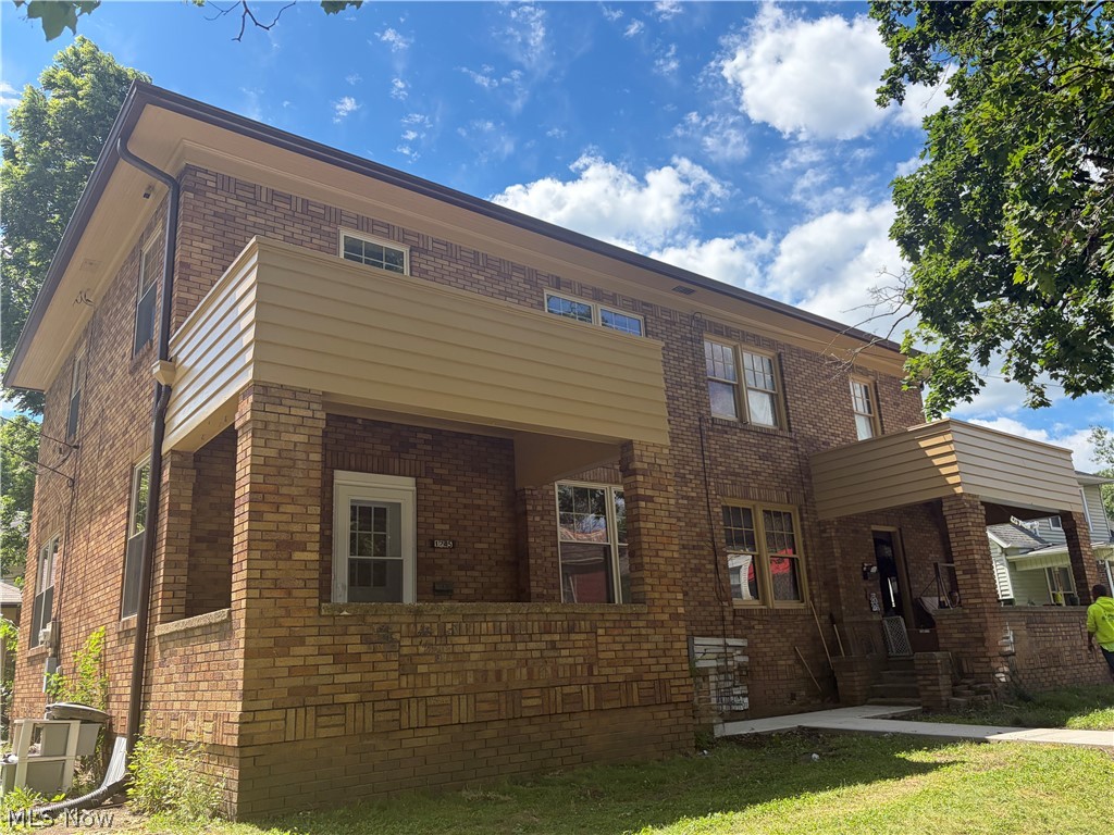 View of front facade with a front yard and brick siding