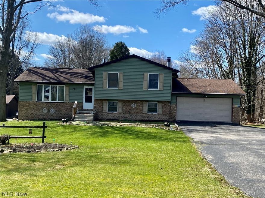 Quiet location, unique 1.48 Acre lot ready for varied outdoor family and garden activities with fire pit and wooded back.  Built in 1990 this 4 bedroom, 2 full bath, 4 level split has much to offer.  Country kitchen and dining room with slider to covered back deck.  Appliances include range, refrigerator, portable dishwasher with stand, washer, dryer, central air, and sump pump.  Full wall beautiful brick light-color brick wood-burning fireplace in family room.  Attached 20 x 20 two-car garage with new main door, lots of vehicle parking area.  Skylight in kitchen and main bath, new front screen door, vinyl and shutters 2006, new roof 2012, second bath remodeled 2020 with modern tile.  Water softener currently rented $22 per month.  Furnace services 2021.
Neutral walls   Tallmadge City Sewer    Selling As Is   Quick access to I-76   Listing agent related to the Seller    
Seller going to miss great neighbors