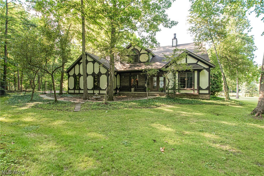 Get ready to be impressed! This stunning waterfront estate & unique European secluded paradise with tranquil lake & wood views. Enter through leaded glass double doors to embrace crystal chandeliers & breathtaking lake views seen through a 20 ft glass door wall. The Grand Room boasts a 22 ft high & 8 ft wide stone wall fireplace with a lighted cathedral oak ceiling. The curved oak stairway leads to the marble-floored loft overlooking the Grand Room & fireplace. If you love to cook then this 9 ft. gourmet kitchen is for you. There is ample storage and counter space in addition to stunning views of the lake. Tray ceiling in Dining Room displays hand-painted Biltmoor replica wood trim. The first-floor Master Suite has a corner floor-to-ceiling stone fireplace. The master suite & adjoining den have Brazillian cherry & walnut inlay floors & cathedral oak ceilings. Custom closet & 12x17 ft bath with 22 ft cathedral skylit ceiling, heated ceramic flooring, jacuzzi, shower & water closet w