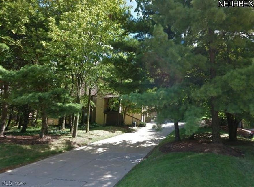 The ultimate in convenience.  Carriage House in desirable Hampton Woods. Second Floor living space.  Stairs lead from entrance into spacious, open Great Room with fireplace and balcony.  Kitchen open to Dining Area.  2 bedroom and 2 full baths PLUS a small office.  Private Laundry Room.  2 car attached garage.  Newer roof and skylights.  Great location near Seiberling Naturealm. Pool/tennis community.  HOA fee is $151/mo. Call today!