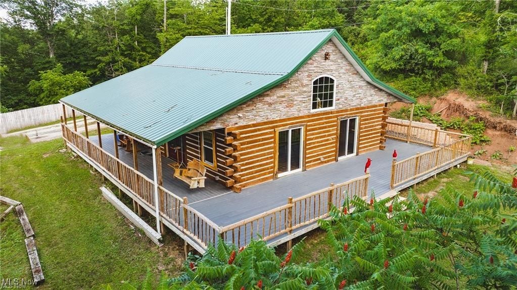 Stunning New Log Cabin Retreat with Ohio River Access. Rustic Charm Meets Modern Comfort! Nestled on a private stretch of 3 acres of land including 60 feet of river frontage, this custom-built log cabin is a rare gem offering peace, luxury, and direct access to the Ohio River—complete with a private boat dock for endless adventures on the water. 3 spacious bedrooms, including a master suite with three closets for ample storage. 2 bathrooms featuring luxury finishes, including a spa-style 8x4 walk-in tiled shower and a classic clawfoot soaking tub. Cathedral ceiling creates an open, airy feel in the main living space as well as 2 glass sliding doors leading to the rear deck to enjoy the incredible views! Eat-in kitchen with gorgeous granite countertops, oak cabinets and stainless steel appliances. Convenient laundry room just off the kitchen. Large rear deck and wrap-around porch — perfect for relaxing or entertaining. Logs harvested from the property were used for siding and accents, adding unmatched authenticity and warmth. Garage Space Galore, Brand new, detached pole garage with multiple uses – ideal for vehicles, workshop, or recreational storage. Additional storage garage on-site for your outdoor gear, tools, or seasonal items. This home is built for all seasons including a durable metal roof. Constructed with quality and care to blend seamlessly with the natural surroundings. Privacy & Seclusion, surrounded by mature trees and nature, enjoy your own peaceful escape while all the leaves fall in Autumn you can enjoy the views of BOTH rivers, just minutes from local conveniences. Whether you’re looking for a full-time residence, vacation home, or investment opportunity, this log cabin offers unmatched value and character. Schedule your private tour today and experience riverfront living at its finest!