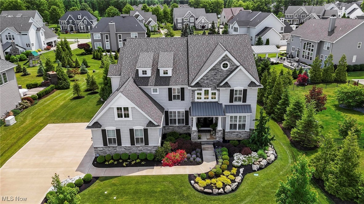 Welcome to this impeccable newer-construction home, built in 2020, offering 3,580 sqft of beautifully finished living space located in Legacy Pointe. The home has 5 spacious bedrooms & 4 full bathrooms. Move right in & enjoy high-end features, luxury finishes, & thoughtful design throughout.
Step into the impressive two-story foyer, flanked by a private office with custom built-in bookshelves & a formal dining room perfect for entertaining. The heart of the home is the chef's dream kitchen, featuring a 10-foot island, granite countertops, stylish backsplash, KitchenAid stainless steel appliances (including a second oven), & an adjoining eat in dining space with sliding doors leading to the backyard retreat.
The two-story family room offers a cozy yet grand atmosphere with a gas fireplace, while the custom mudroom, laundry room, & main-level in-law suite with a full bath & walk-in closet with custom built ins, provide both function & flexibility.
Upstairs, find two generously sized bedrooms with walk-in closets connected by a Jack & Jill bathroom with granite countertops & separate water closets. A third upstairs bedroom features an ensuite bath & custom walk-in closet. The primary suite is a true sanctuary with vaulted ceilings, a spa-like bathroom with a massive walk-in tile shower, dual granite vanities, & an oversized walk in closet with custom built ins that will impress.
Throughout the home, you'll find engineered hardwood flooring, tile in all wet areas, plantation shutters, surround sound, & even an invisible fence for pets, and a whole home generator for peace of mind.
Enjoy outdoor living at its finest with a gorgeous paver patio, built-in grill, fire pit, gazebo, & hot tub, all surrounded by mature landscaping. The full basement has 9' ceilings waiting for your finishing touches. Enjoy all the amenities that Legacy Pointe has to offer including the community pool, tennis & pickle ball court, workout facility & golf.