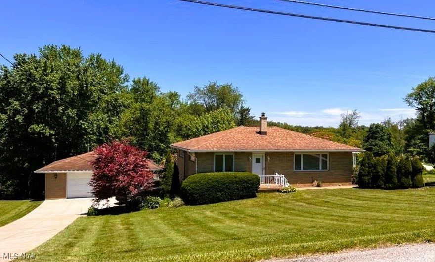 This beautifully maintained brick ranch home is situated on just over 1 acre, just minutes from the St. Rt 7 & 22 interchange.  You will never want or need to leave home.  The indoor contains 3 bedrooms, 2 full baths, and a stunning new kitchen with Cambria quartz counters.  The large third bedroom and second bath are on the lower walk-out level. This area would be perfect for a master suite, teen room, or MIL suite.  The lower level also features a rec room, an area that was formerly a kitchen and just needs the sink installed again, a wood-burning furnace, and a pebble stone entry area that previously housed a hot tub.  Outside is a detached 2-car garage with a workshop area and partial basement, mature landscaping, and a perfect summer entertainment area featuring a pavilion, fenced in, and containing salt water in-ground pool.  The backyard is lush with raised garden beds and trails through the wooded area that extends well behind the pool area.  Make your appointment today!