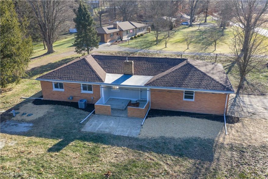 Beautifully updated interior with new custom kitchen with quartz counter tops and tile back splash. New SS appliances, 2 new bathes, new plumbing,  new breaker box, new furnace and ac, all new doors, interior and exterior. All new interior paint, lighting, flooring thru out the home. New concrete basement steps and a new basement wall installed by Superior Basement Systems and some new windows. The floorplan has the open concept, great for entertaining There is a wood burning fireplace in the living room, never used by seller. Bath has a dble vanity, built in cabinet for storage , shower/tub combo, plus a new half bath . Color palette is a soft gray thru out the home with white trim, enhancing the natural light. Location is close to grocery and  I77, just minutes to Canton.