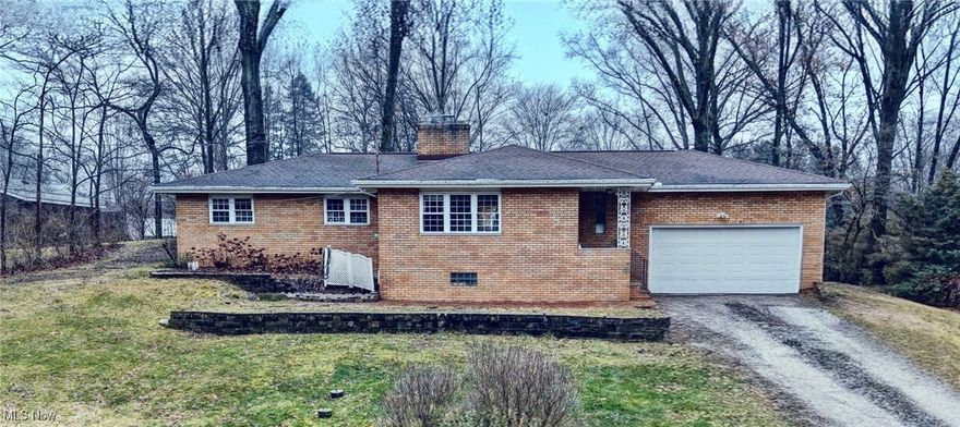 NEW SEPTIC!! Welcome home to this all-brick ranch with three bedrooms, one and half bathrooms. As you enter through the front door, the large living room with stone gas fireplace is open to the dining room. The bright kitchen has subway tile back-splash, ceramic tile flooring, stove, built in microwave, refrigerator, and dishwasher. All bedrooms offer hardwood floors and large closet space. Both bathrooms feature ceramic tile floors. The lower level offers a finished section with carpet and could easily be another bedroom, family room, etc. and includes a second fireplace. Roughed in plumbing available. Unfinished section has the laundry area and plenty of room for storage. Large backyard has a patio and plenty of space for entertaining. Shed. Two car garage. Some updates include water softener 2024. Water heater 2022. Located within minutes from I-77 and shopping, restaurants. All you have to do is move in!