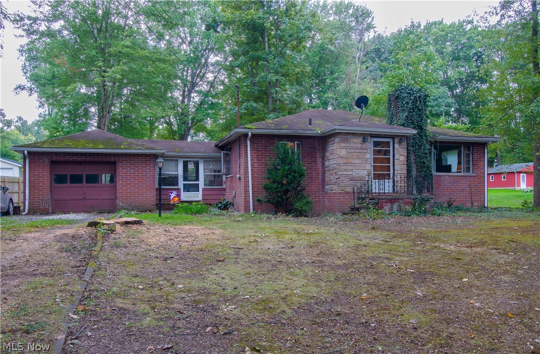 Property sold AS IS. This brick Ranch home sits on almost an acre (.88-acre) in a quiet cul-de-sac near Portage Lakes. This home offers three bedrooms, a full bath, a spacious living room, an eat-in kitchen with plenty of cabinet space and a dining area, a full basement with the potential to be finished, and a breezeway with an attached one-car garage. The location is easy to access in Akron, Canton, or surrounding areas. Make an appointment for your private showing today!
