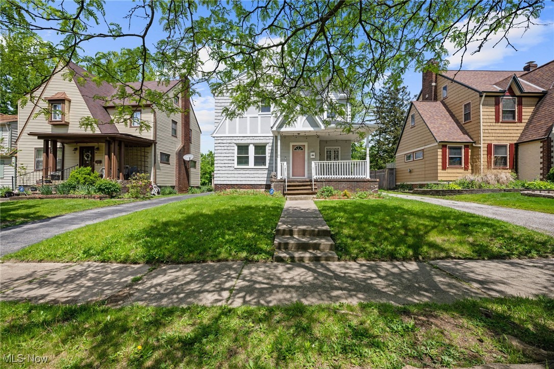 Welcome to 1047 Hillstone Road—a beautifully updated Colonial nestled in the heart of Cleveland Heights. From the inviting front porch and cheerful pink door to the thoughtful upgrades throughout, this home blends classic charm with modern comfort. Inside, you'll find a sunlit living room, a formal dining room with original built-ins, and a renovated kitchen featuring white shaker cabinets, granite countertops, stainless steel appliances, and fresh tile flooring that flows into a spacious eat-in area. A stylish powder room completes the main level. Upstairs, a bright three-season sleeping porch greets you at the top of the stairs, leading to a hallway with classic built-in cabinetry and an elegantly remodeled full bath with Carrara-inspired tile and updated fixtures. The primary bedroom offers a peaceful retreat, complemented by two additional bedrooms. The finished third-floor loft adds flexible space for an office, playroom, or guest suite. Some recent improvements include new flooring, lighting, plumbing, paint, exterior touch-ups, gutter work, and a newly installed rear walkway. The backyard is ideal for entertaining, and a two-car detached garage adds convenience. Just minutes from Coventry Village, Cedar Lee, Cain Park, and Lake View Cemetery, this home offers timeless style, modern updates, and an unbeatable location.