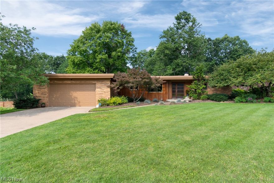An incredible Mid-century modern home on 1.3 acres in Perry schools!  This three bedroom, two bathroom home has kept the original charm of a Mid-century modern with neutral decor.  Custom built-ins throughout and a breakfast bar that overlooks the yard.  The storage throughout the home is abundant.  There are two closets in the primary bedroom and the other bedrooms have large closets as well.  The big windows provide views of the amazing backyard.  From inside your home you can access the backyard from the primary bedroom (which leads you to the covered patio) or the incredible screened porch (which leads you to the patio).  The fenced back yard is great for pets, kids, or privacy.  This property has so much to offer- 1.3 acres, hard to find Mid-century modern, Perry schools, clean and move-in ready. Book your showing and see for yourself.