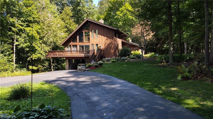 RARELY FOUND...Your own private retreat tucked away in a Wooded 4.2 Acre location only 2 miles from Wooster...This beautifully landscaped Open Concept 4 Bedroom/3.5 Bath Cedar Contemporary home with Walk-out lower level and large wrap-around deck overlooking a wooded ravine with meandering spring fed creek also comes with a terrific 2-Story 38'x40' Building providing for additional 3-car garaging and large workshop...Unique touches found throughout the home reflect the known artist and craftmanship ability of the owners of this one-owner custom built home...2 sets of glass sliding doors leading to the wrap-around deck, a 2-story stone wall fireplace and California redwood sapwood paneling accent the Great Room...an antler inspired chandelier and glass sliding doors leading onto the rear deck highlight the Dining area...the Kitchen features an island and walk-in pantry along with a pass-thru window and door providing easy access for delivering food/beverages to the 4-Season Sun Room and