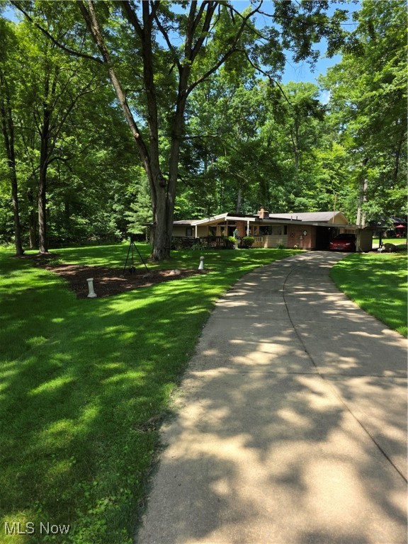 This home is one of 4 built by David Kerr who studied with Frank Lloyd Wright. Something to see. The use of brick, wood and other materials show custom work. Large walk-in closet in master. Built-ins everywhere, tons of closet space. Living room has Tectum Ceilings. (Acoustic wood panels) vaulted ceilings. Third bedroom could be used as an in-law suite. 4 car detached garage w/gas. All season sunroom has lots of room. Lot is on a "U" shaped road. This home sits on back of the "U". Nothing but trees an quiet. An occasional deer show up. Lots of new and almost new features. Little peace of paradise. Located close to everything.