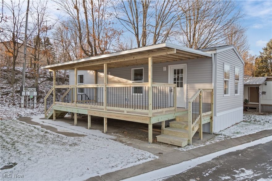 Welcome to this brand-new, manufactured home in a serene 55+ community, designed for easy, one-floor living!

Enjoy outdoor activities on the brand-new, covered wood deck which spans the length of the home! It was custom-built in Nov 2024 and highlights two entrances.

Step inside the bright living room, bathed in natural light from windows on all sides. A charming wood beam and ceiling fan add a cozy touch.

The beautiful kitchen offers a center island/breakfast bar, extensive cabinetry, and sleek stainless steel appliances.

Washer and dryer hookups are also conveniently located in the kitchen for true ease.

There is a spacious bedroom with storage and a ceiling fan. The full bathroom completes the living space.

This property is perfectly situated near shopping, restaurants, and expressways, making it an ideal location for both convenience and quiet living.

With an extremely low monthly lot rent of just $330, this home is the perfect balance of affordability and comfort, waiting for you to make it your own!

Call us to schedule your private showing today!