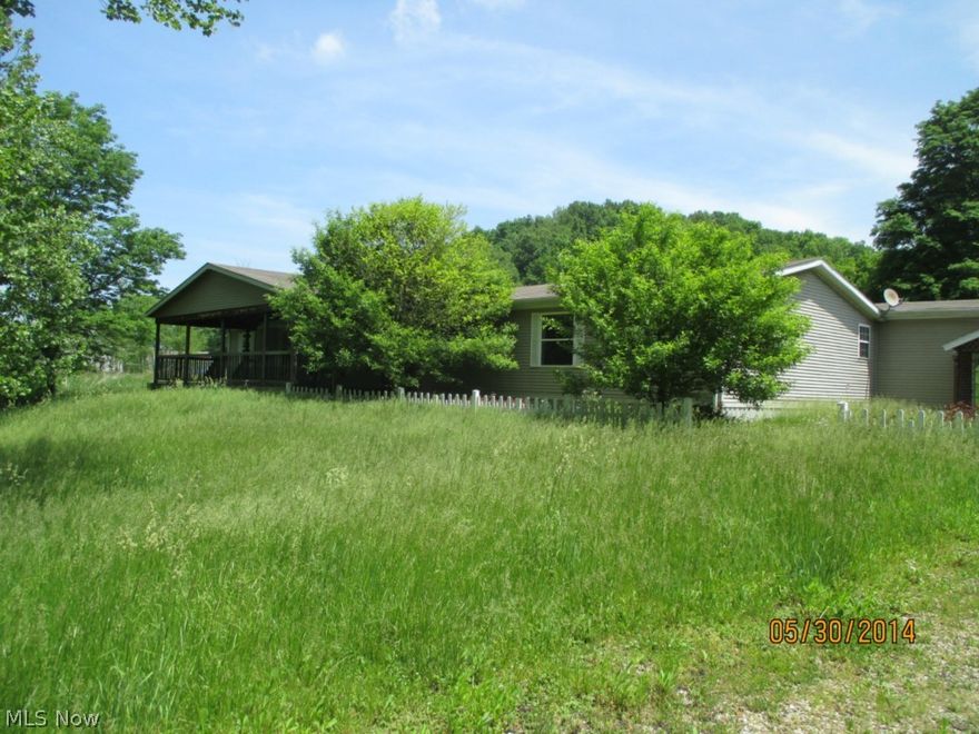 Great location.  Minutes from The Wilds and AEP Public Hunting Lands.  Possible horse farm.  Front pasture has a creek separating it from the home.  House has two magnificent decks and a 2 car detached garage with a covered walkway to house.  Backyard is partially wooded.  Great retreat.  Hunters paradise.  Some TLC needed.