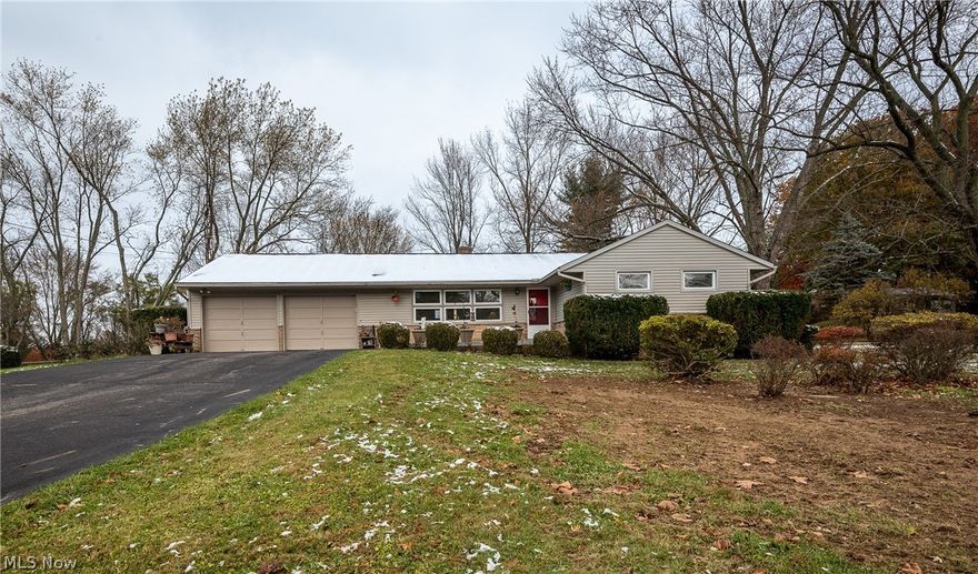 Country living at its best!  This absolutely adorable 3 bedroom ranch will make you smile! Located in the heart of Lake Twp. featuring  Lake Schools and 2 plus acres with lots of possibilities!  Spacious living room with electric fireplace and open to the dining area and kitchen that is just charming.  Updated full bath and 3 bedrooms with cork flooring.  Full basement with 1/2 bath and potential for a full bath - lots of storage and stairs to the oversized 2 car garage.  You will fall in love with the backyard views and all the space you will have!