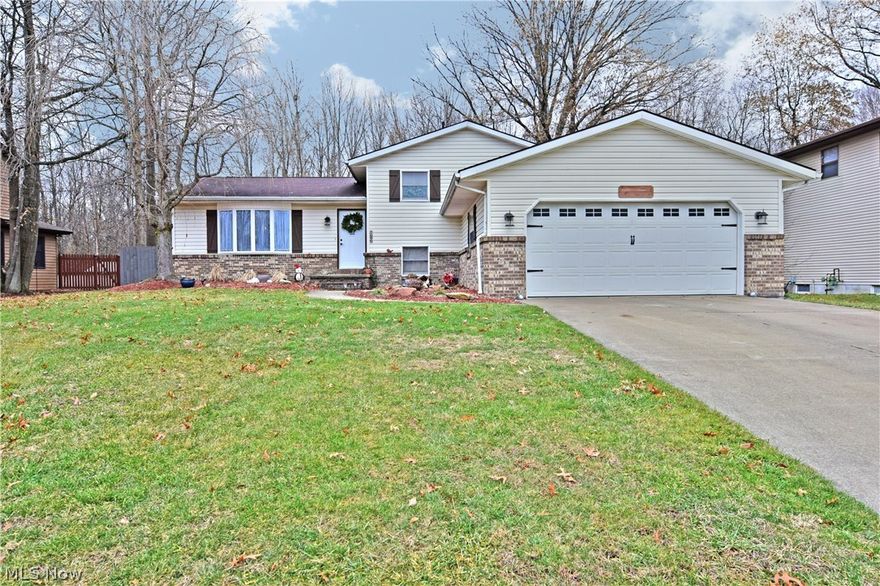 Act now and don’t miss your chance to own this spectacular split-level home, complete with a fenced in backyard and huge in-ground pool! This residence features a host of high-quality updates throughout. A beautiful exterior has been treated to tasteful lower brick work, as a concrete drive and walk way leads past tidy landscaping to the front door. Inside, a stunning living room immediately grabs your attention with sculpted partition walls and lush natural colored carpets that pair with soothing gray walls. Bright white trim ties the room together as the combination echoes through each room. A masterful kitchen shares the floor plan with a sizeable dining area. Here, granite countertops reflect the stark white cabinets and modern stainless appliances. A uniquely tiled backsplash adds to the style, matching colorways with the ash like hardwood flooring. A sliding glass door allow for plenty of natural light and instant poolside access. Upstairs, a trio of spacious bedrooms with great closet space find their way before a lovely full bath. Here, modern updates include a decadent vanity and matching shower area; as custom tile cover the floor and walls. Downstairs, a relaxing carpeted family room awaits with a prominent brick fireplace. A fourth bedroom can be found near an additional full bath area, with modern single vanity and more custom tile work. A fourth basement level provides for additional storage below and laundry area. This home comes with a 2-10 Home Warranty.