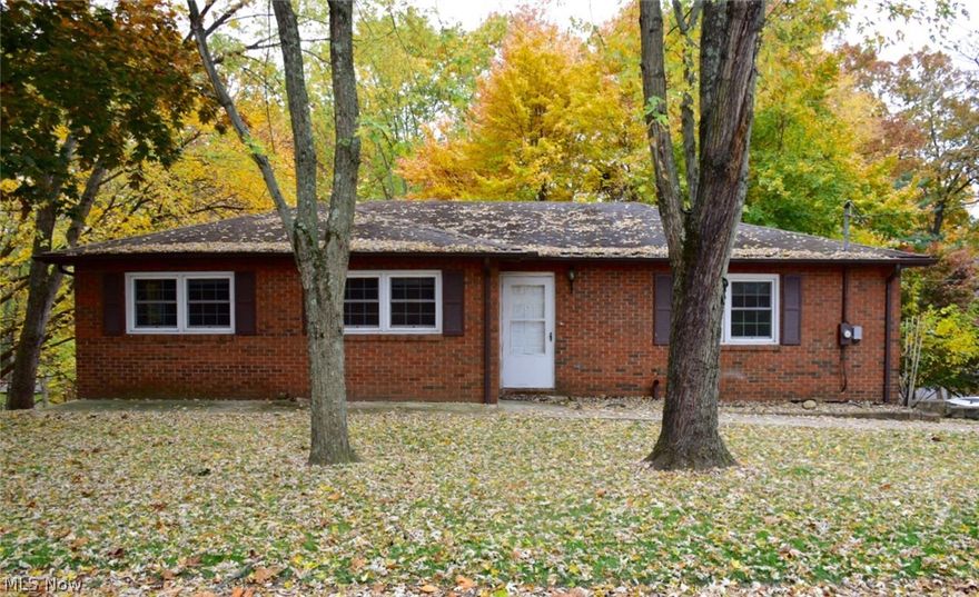 Enjoy country living in the city, in this peaceful, quiet north end neighborhood!  Walk out onto the 3-tiered deck to enjoy the trees and wildlife on this corner lot with 3 parcels!!  New bamboo cherry hardwood floors installed in the living room & oversized hallway, 2-3 yrs ago!  Newer windows!  One bathroom has a new toilet & the other has a new toilet & sink!  New carpet on the steps to the basement, appx. 2-3 years ago!  Deep closets!  Work room off the garage in which the table saw can stay too!  Lots of open space to spread out and enjoy this beautiful brick home!