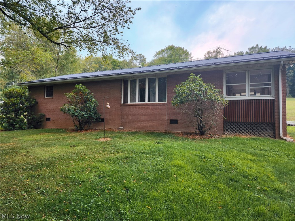 Discover the perfect blend of seclusion and convenience in this charming ranch-style home. Spread across 2.238 acres, this brick home offers a serene escape with large, beautiful trees providing natural privacy and a picturesque setting. The property features two bedrooms, two bathrooms and laundry all on one floor for easy living. A carport adds to the convenience, and the tree-lined surroundings enhance the feeling of being nestled in nature. Enjoy the sunroom porch in any weather. Despite its rural ambiance, this home is close to town, giving you the best of both worlds—peaceful seclusion with all the amenities nearby. Ideal for those seeking a quiet, private retreat that is still connected to the community. Property also has a 20 x 50 outbuilding which could be refurbished. Home is being sold As Is; Estate