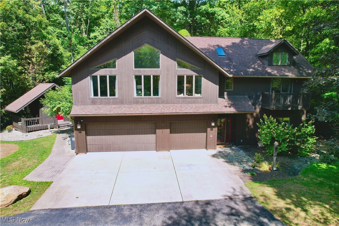 Discover this unique 4 bedroom, 3 full bathroom home in a prime Canfield location, providing easy access to shopping and Route 11 while maintaining a serene atmosphere surrounded by woods. Nestled within the Canfield School District on 1.23 wooded acres, this reverse floor plan residence offers the perfect blend of privacy and stunning views.
Step inside to find a bright and airy open floor plan with vaulted ceilings, ideal for entertaining. Each of the four spacious bedrooms features its own recently re-stained balcony, enhancing the home's charm. The master suite boasts a walk-in closet and a luxurious master bathroom complete with a steam shower featuring dual shower heads and a double sink.
On the first floor, you'll find a convenient half kitchen, a laundry room, a third full bathroom, bedroom and a cozy living room with updated flooring. Access the upstairs kitchen via a stylish spiral staircase or the back staircase for added convenience.
This property also includes a heated 3-car garage, a fire pit, a tree house, and two sheds, offering plenty of outdoor fun and storage. Recent updates include a new AC unit in 2020, an upgraded water treatment system, a stunning 3D backsplash in the upstairs kitchen, new light fixtures, and smart LED Alexa lights, along with a new hot water tank installed in 2021.