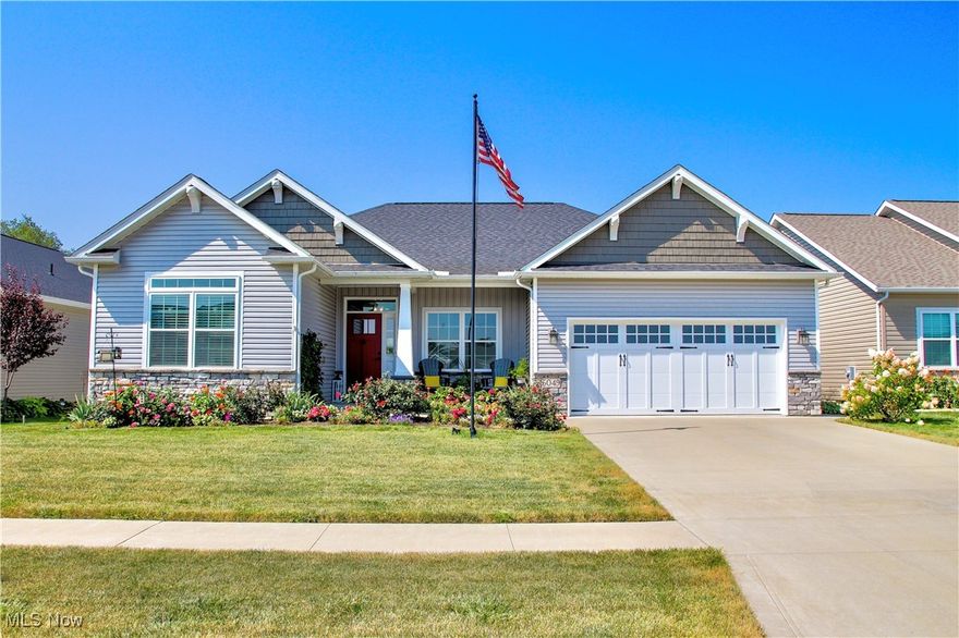 Welcome Home! This stunning property combines thoughtful design with modern comfort. With 4 bedrooms, 3 baths, and over 3,600 finished square feet including a custom-finished lower level, it is one of the largest homes in Autumn Meadows. The front porch sets the tone, leading into an open entry flowing into a bright living, dining, and kitchen area. The kitchen features quartz countertops, stainless appliances, under/over cabinet lighting, a large pantry, and two retractable outlet stations with wireless charging. The living room centers around a stone gas fireplace framed by transom windows and a custom mantle, while upgraded fixtures and recessed lighting highlight the home’s quality throughout. Craftsman-style doors, wood flooring, and custom blinds elevate every room. The primary suite offers a serene retreat with large windows, a walk-in closet, dual vanity, walk-in shower, and generous linen storage. A third bedroom on the main level is currently used as an office with a custom barn door, while the first-floor laundry includes a built-in bench. Downstairs, the finished lower level feels like an extension of the home, with a rec room, a 4th bedroom with egress, a full bath, and two large storage areas. There is plumbing rough-in for a future kitchenette. Outside you’ll find a covered porch with recessed lighting, a ceiling fan, and illuminated railings that lead to a patio. Exterior details include craftsman-style lighting, stone accents, shake siding, and custom house numbers built into the façade. The property backs to the Seville walking trail and the HOA provides access to a stocked lake. Autumn Meadows maintains beautifully kept surroundings with low annual dues and guidelines that preserve neighborhood character. Just minutes to I-71 and I-76/224, offering quick access to Akron, Cleveland, and Medina. A two-car garage, exterior outlets for holiday lighting, and thoughtful extras complete the package.