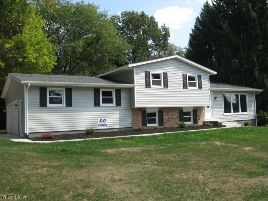 This stunning split level home located in Perry Township has been completely remodeled and on a double lot!  From the floors to the ceiling, it's all updated!  Step into this home and the first thing you notice is the floor to ceiling window in the living room, giving you great views of the outdoors.  Recessed lighting and beautiful new carpet.  Continue on and you come into the stunning new kitchen.  All new cabinetry, counter tops, tons of space.  Black appliances include dishwasher, stove, and built in microwave.  Perfect eating area, again with a very large window with great views of the backyard!  The lower level offers sliders to the back yard, partially bricked wall, perfect if you want to add a wood burner, and new carpet and a half bath.  All 3 bedrooms boast wood floors, and a large updated bathroom.  Two car garage with new garage doors and when you enter through the garage door, you conveniently enter into the mud room.  New vinyl, new roof, and updated landscaping!  Nothin